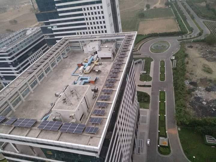 Rooftop solar panels around the roof of a multi-storey residential block