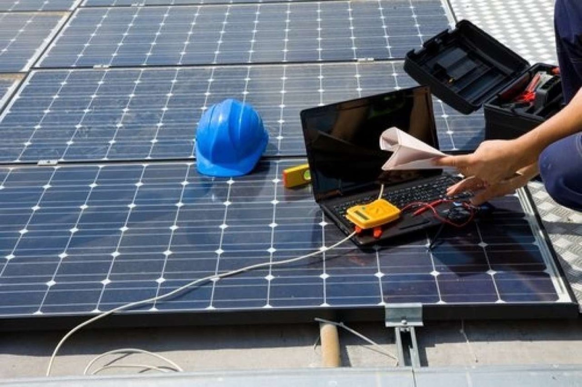 Engineer running diagnostics on a solar system